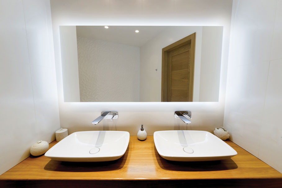 Halo bathroom lighted mirror installed in a bathroom above 2 sinks