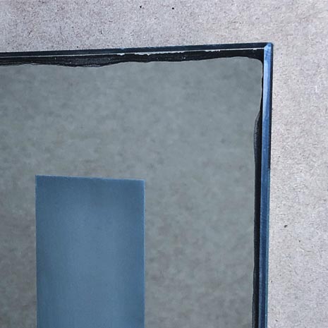 Inexpensive cheap mirror, showing the black edge tarnishing