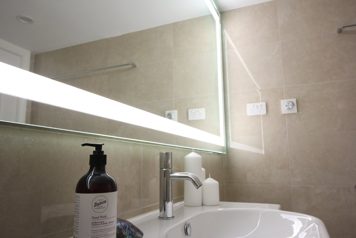 A big illuminated mirror in the bathroom