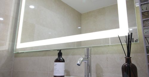 Big illuminated Mirror in a Small Bathroom